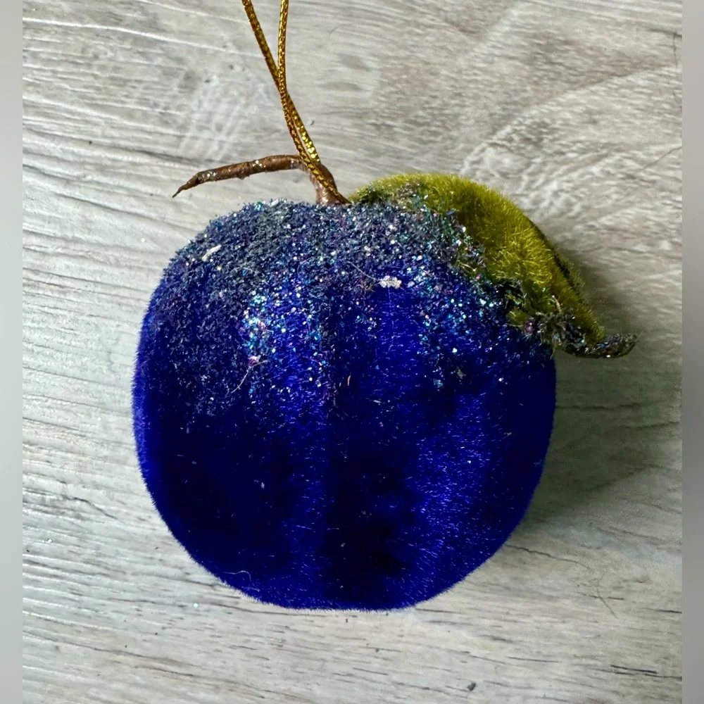 Christmas tree ornament. A plum-shaped ornament covered in glitter. The ornament